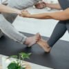 What Are the Advantages of Regular Physical Activities? 5 crop couple stretching together on mat