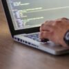 A Guide to Outsourced Software Testing 3 person encoding in laptop